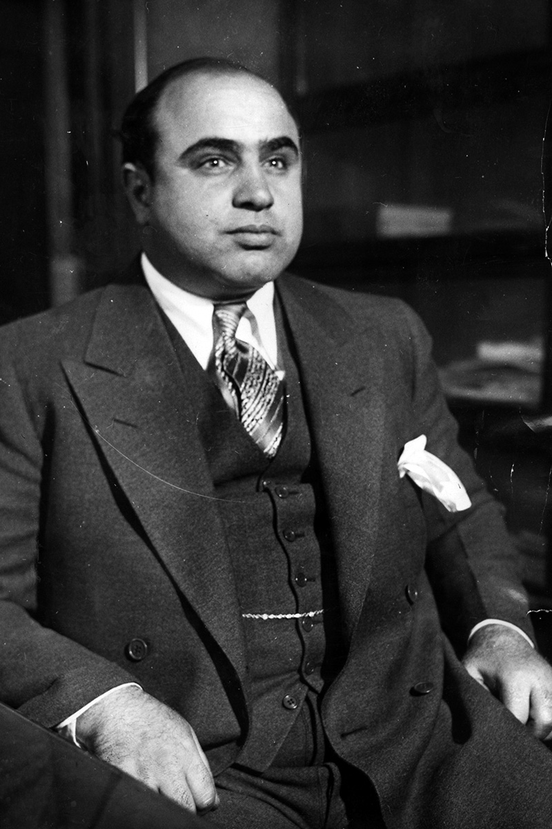 Picture of Al Capone. 8 x 10 black & white original wire photograph that has attached the original news bureau caption on verso, dated “2-26-31.” The caption describes his appearance before the Chicago Detective Bureau on vagrancy after a court appearance at the hands of Federal marshals on contempt.